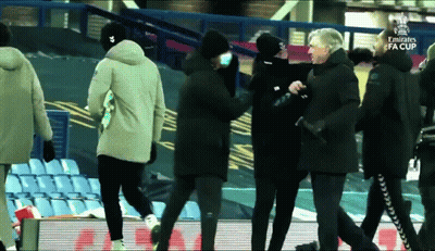 A Group Of People Walking On A Soccer Field With The Emirates Fa Cup Written On The Bottom GIF
