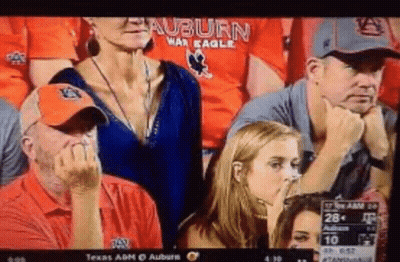 A Group Of People Watching A Football Game With The Auburn War Eagles On Their Shirts GIF