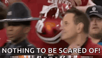 A Group Of People Watching A Football Game With The Words Nothing To Be Scared Of On The Screen GIF