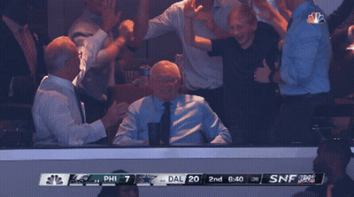A Group Of People Watching A Game With A Scoreboard That Says Phil 7 Dal 20 GIF