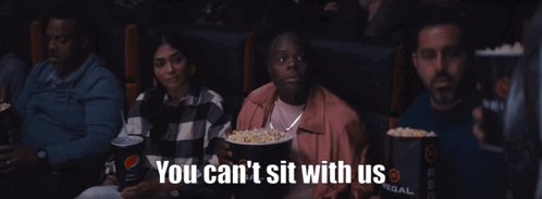 A Group Of People Watching A Movie With The Words You Can 'T Sit With Us Below Them GIF