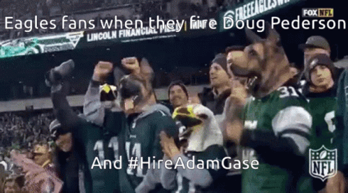 A Group Of People Wearing Eagles Jerseys Are Standing In A Stadium GIF