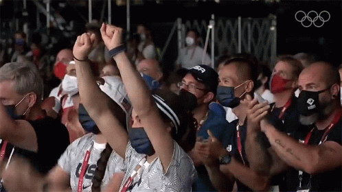 A Group Of People Wearing Face Masks Are Applauding While Wearing Us Shirts GIF