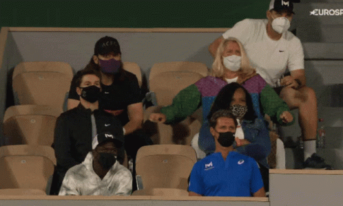 A Group Of People Wearing Face Masks Are Sitting In A Stadium With A Eurosport Logo Behind Them GIF