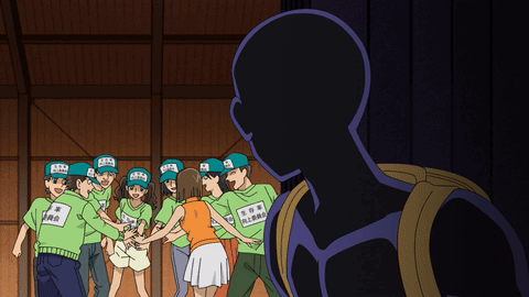 A Group Of People Wearing Green Shirts With Chinese Writing GIF