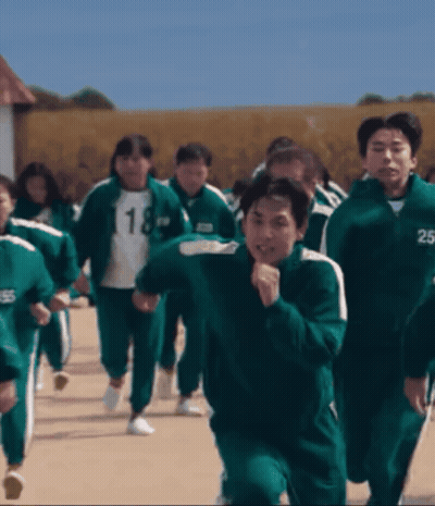 A Group Of People Wearing Green Uniforms With The Number 18 And 25 On Their Jackets GIF