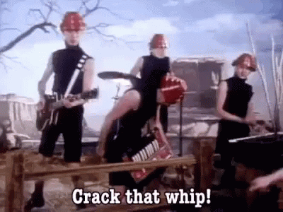 A Group Of People Wearing Hard Hats Are Playing Instruments And Singing A Song . GIF