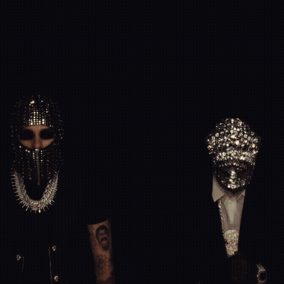 A Group Of People Wearing Masks Are Standing Around A Couch GIF
