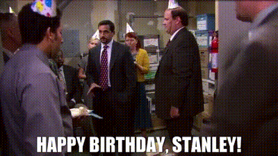 A Group Of People Wearing Party Hats Are Standing In A Room With The Words Happy Birthday Stanley . GIF