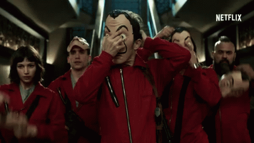 A Group Of People Wearing Red Jumpsuits And Masks With A Netflix Logo In The Corner GIF