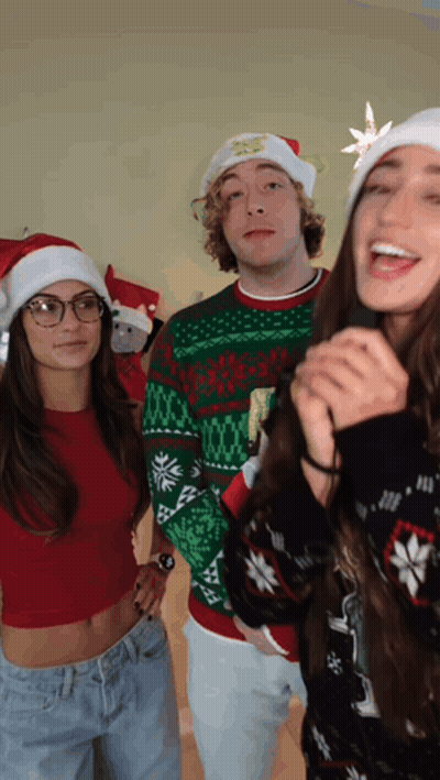 a group of people wearing santa hats and ugly christmas sweaters