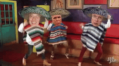 A Group Of People Wearing Sombrero 'S And Ponchos Are Dancing In A Room . GIF