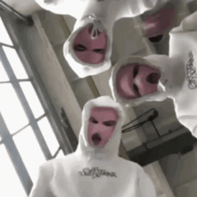 A Group Of People Wearing White Hoodies And Pink Ski Masks . GIF