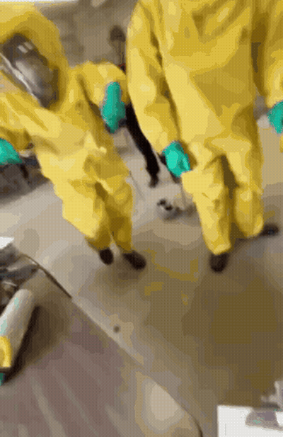 A Group Of People Wearing Yellow Suits And Gloves GIF