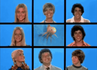 A Group Of People With A Fish In The Middle GIF
