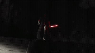A Group Of People With Red Lightsabers In The Dark GIF