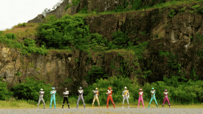A Group Of Power Rangers Are Lined Up In Front Of A Rocky Hillside GIF