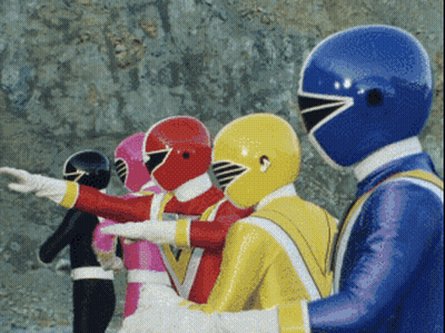 A Group Of Power Rangers Are Standing In A Row With Their Arms Outstretched GIF