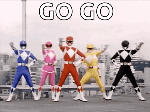 A Group Of Power Rangers Are Standing Next To Each Other And Waving Their Hands In The Air . GIF