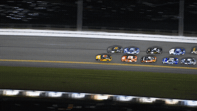 A Group Of Race Cars Are Racing On A Track And One Of Them Has The Number 9 On It GIF