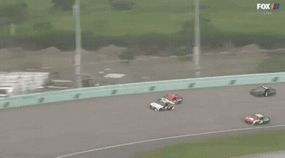 A Group Of Race Cars Are Racing On A Track With Fox Broadcasting GIF