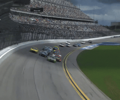 A Group Of Race Cars Are Racing On A Track With The Letter B On It GIF