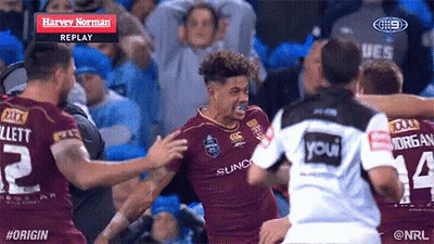 A Group Of Rugby Players Are Hugging Each Other And One Of Them Has The Number 14 On His Shirt GIF
