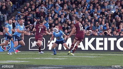 A Group Of Rugby Players Are Playing A Game Of Rugby In Front Of A Crowd . GIF