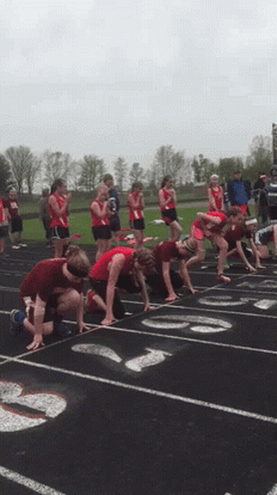 A Group Of Runners Are Getting Ready To Run On A Track GIF