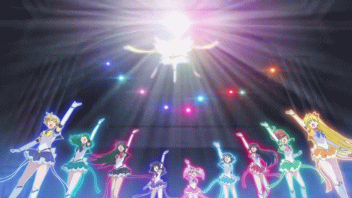 A Group Of Sailor Moon Characters Are Standing In A Circle With Their Arms In The Air . GIF
