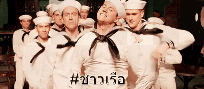 A Group Of Sailors Are Standing In A Line And One Of Them Has The Word # On His Chest GIF