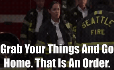 A Group Of Seattle Firefighters Standing In Front Of A Fire Truck GIF