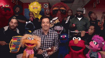 A Group Of Sesame Street Characters Are Posing For A Photo With Jimmy Fallon GIF