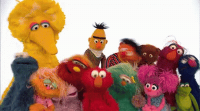 A Group Of Sesame Street Characters Standing Next To Each Other . GIF
