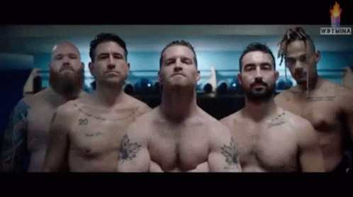 A Group Of Shirtless Men Are Standing Next To Each Other GIF