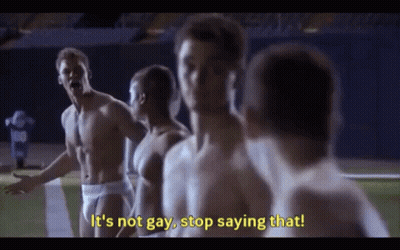 A Group Of Shirtless Men Are Standing On A Football Field And One Of Them Is Saying It 'S Not Gay , Stop Saying That GIF