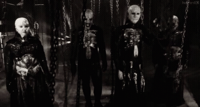 A Group Of Skeletons Are Standing Next To Each Other In A Dark Room . GIF