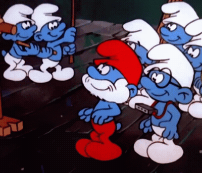 A Group Of Smurfs Standing On A Wooden Floor GIF