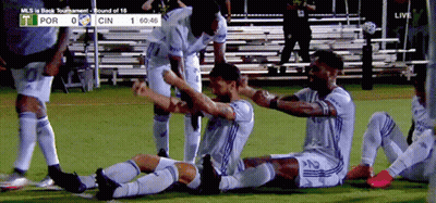A Group Of Soccer Players Are Celebrating A Goal During A Game Between Por And Cin GIF