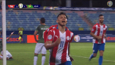 A Group Of Soccer Players Are Celebrating A Goal On The Field . GIF