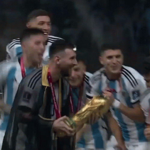 A Group Of Soccer Players Are Celebrating With A Trophy In Their Hands . GIF