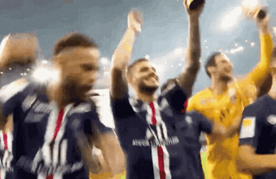 A Group Of Soccer Players Are Celebrating With A Trophy In Their Hands . GIF