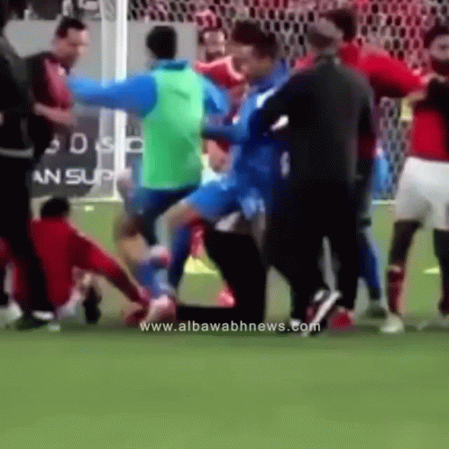 A Group Of Soccer Players Are Fighting On A Field With The Website Www.albawabhnews.com Visible In The Corner GIF