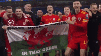A Group Of Soccer Players Are Holding A Flag That Says In That Order GIF