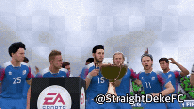 A Group Of Soccer Players Are Holding A Trophy In Front Of A Ea Sports Sign GIF