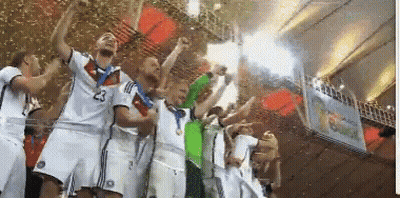A Group Of Soccer Players Are Holding Up A Trophy And One Has The Number 23 On His Shirt GIF