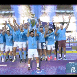 A Group Of Soccer Players Are Holding Up A Trophy In Front Of A Screen That Says Manchester City GIF