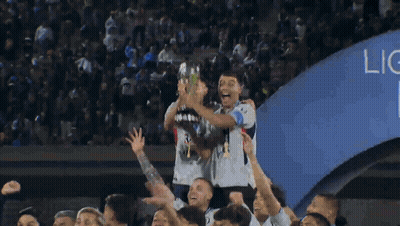 A Group Of Soccer Players Are Holding Up A Trophy In The Air GIF