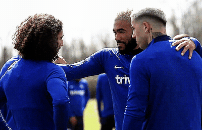 A Group Of Soccer Players Are Huddled Together And One Of Their Shirts Says Triv GIF