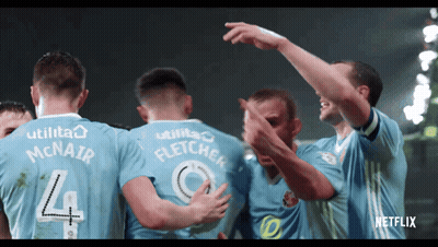 A Group Of Soccer Players Are Huddled Together With One Wearing A Number 4 Jersey GIF
